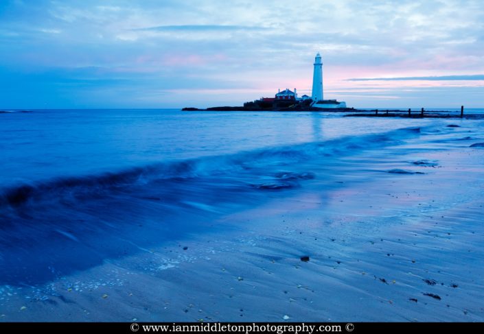 Saint Mary's Lighthouse on Saint Mary's Island, situated north of Whitley Bay, Tyne and Wear, North East England. Seen at sunrise from the beach beside the causeway that runs out to the island. Whitley Bay is situated just north of Newcastle.