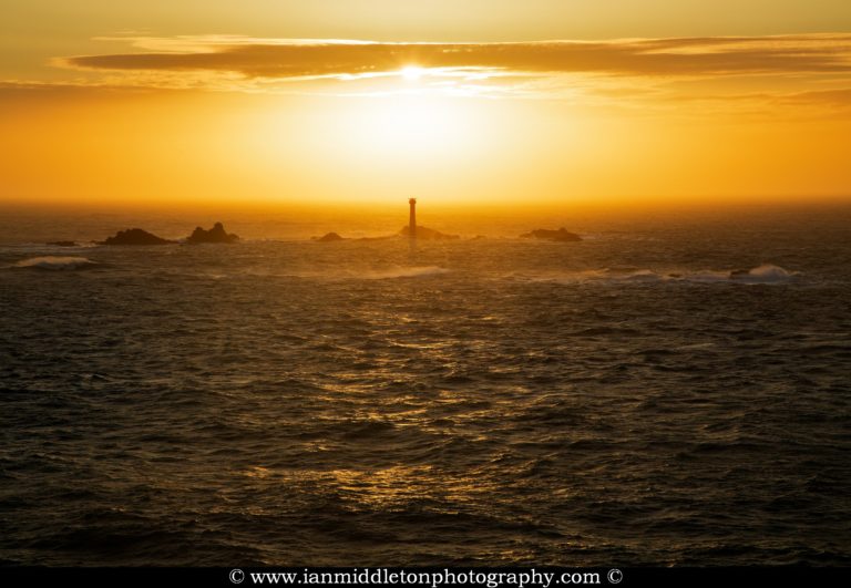 Longships Lighthouse at Lands End, photographed at sunset. Built on the Longships rocks in 1875 at the far southwestern tip of the British Isles, a notoriously deadly section of ocean.