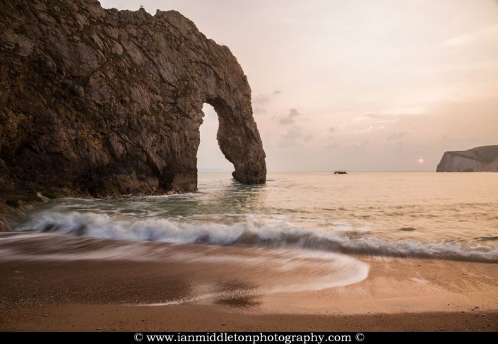 Durdle Door beach as the sun disappears for the day, Dorset, England. Durdle door is one of the many stunning locations to visit on the Jurassic coast in southern England.