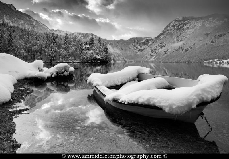 Snow covered boat on Lake Bohinj in Winter