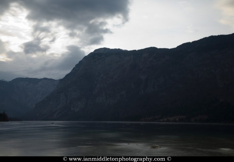 The beautiful Lake Bohinj at dusk, Triglav National Park, Slovenia. This is the largest natural permanent lake in Slovenia situated in a glacial hollow of a dead end valley. The lake has many moods and no matter what the time of year, never fails to produce stunning scenes from all angles.