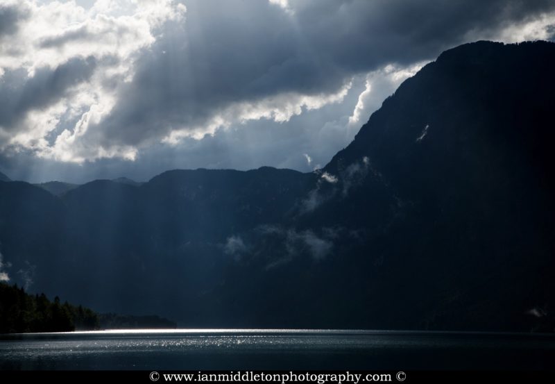 Beautiful light and clouds scattering over Bohinj Lake after a massive storm blew over the Bohinj valley, Triglav National Park, Slovenia.