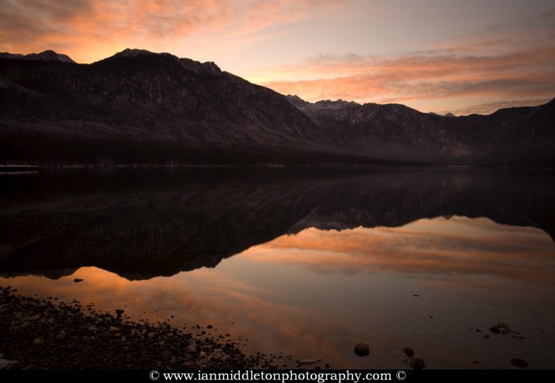 The Julian Alps reflected in Lake Bohinj at the first sunset of the new year, Triglav National Park, Slovenia. Taken New Year Day 2012.