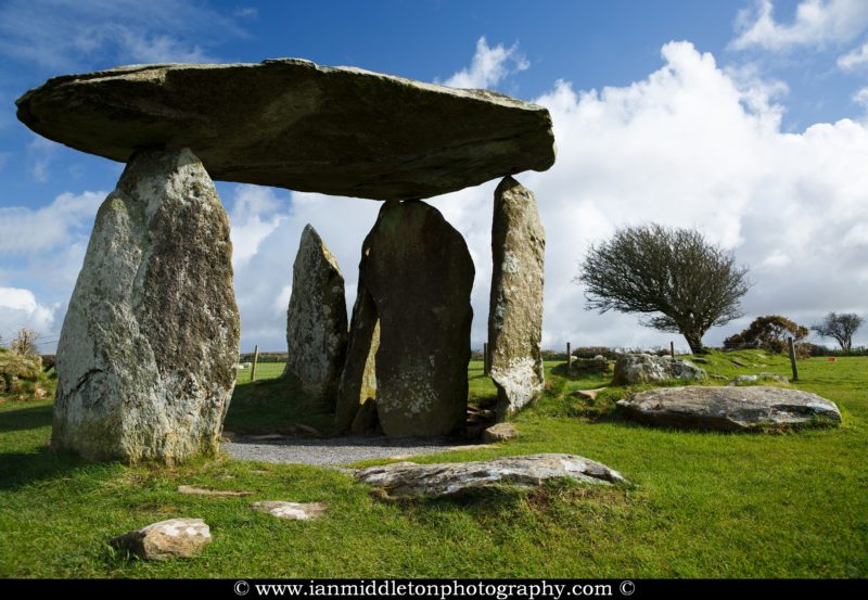 Pentre Ifan Neolithic Burial Chamber, Pembrokeshire, Wales. The Dolmen's huge capstone is delicately balanced on three uprights. Once known as Arthurs' Quoit, Pentre Ifan means Ifan's Village. This monument, dating back to about 3500 BC and unusually oriented north-south, stands on the slopes of a ridge commanding extensive views over the Nevern Valley. The capstone weighs over 16 tons; it is 5m (16ft 6in) long and 2.4m (8ft) off the ground.
