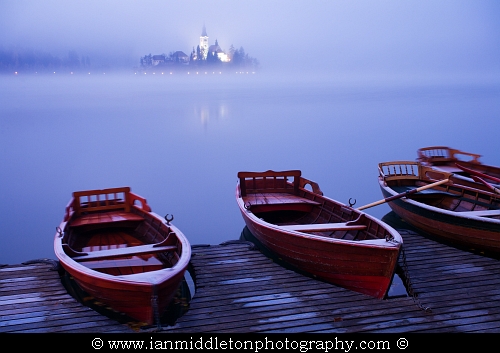 The famous Island church enshrouded in an icy mist and frost over Lake Bled.