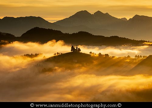 View at sunrise from Rantovše hill across to Sveti Tomaz nad Praprotnim (church of Saint Thomas) and the Kamnik Alps, Slovenia.