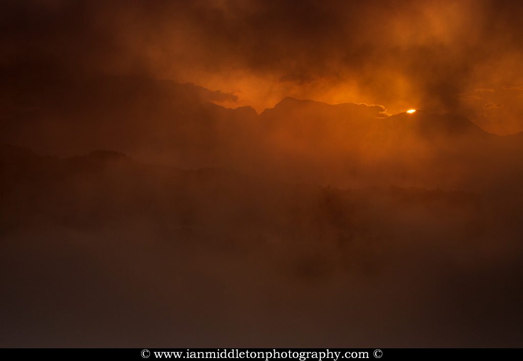Sunrise over the Kamnik Alps through a thick shroud of mist, Slovenia