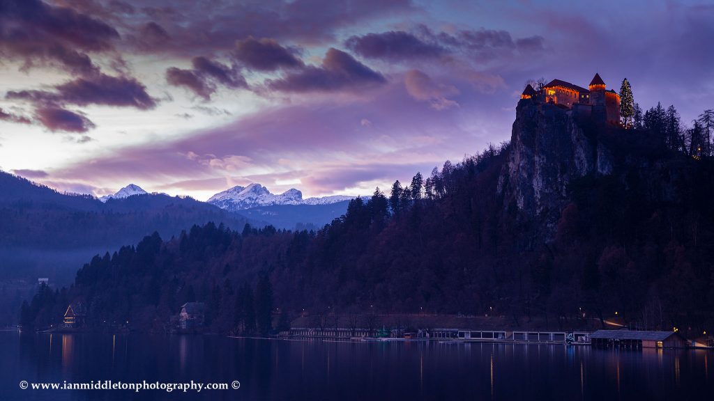 Sunset over Lake Bled and the hilltop castle with the Julian Alps in the background, Slovenia.