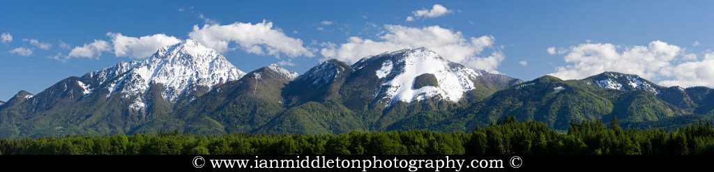 A late spring snowfall on the mountain peaks of Kamnik Alps, Slovenia. Storzic (left, 2132m) and Zaplata (right, 1853m). This is a panoramic image made from 3 photos.
