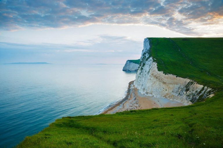 View across the cliffs to Bats Head from the cliffs above Durdle Door beach as the sun goes down for the evening, Dorset, England. Durdle door is one of the many stunning locations to visit on the Jurassic coast in southern England