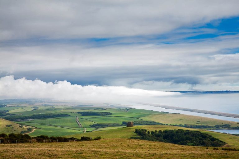 View across to Chesil beach, Saint Catherine's chapel, near the village of Abbotsbury, and Portland in the distance, Jurassic Coast, Dorset, England. This coastline is a UNESCO world heritage site.