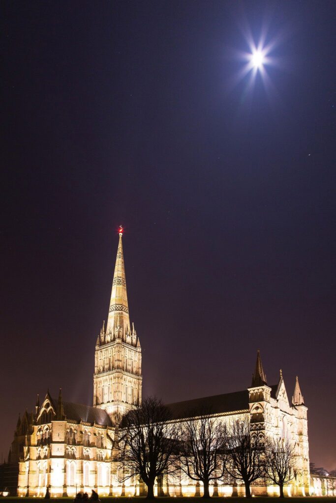 Salisbury cathedral on a moonlit evening, Wiltshire, England. Shot as the moon shone over the spire just after dusk.