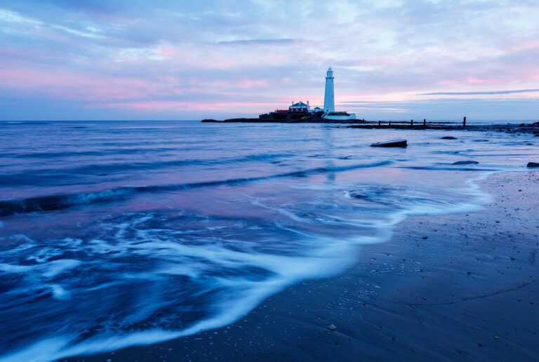 Saint Mary's Lighthouse on Saint Mary's Island, situated north of Whitley Bay, Tyne and Wear, North East England. Seen at sunrise from the beach beside the causeway that runs out to the island. Whitley Bay is situated just north of Newcastle.