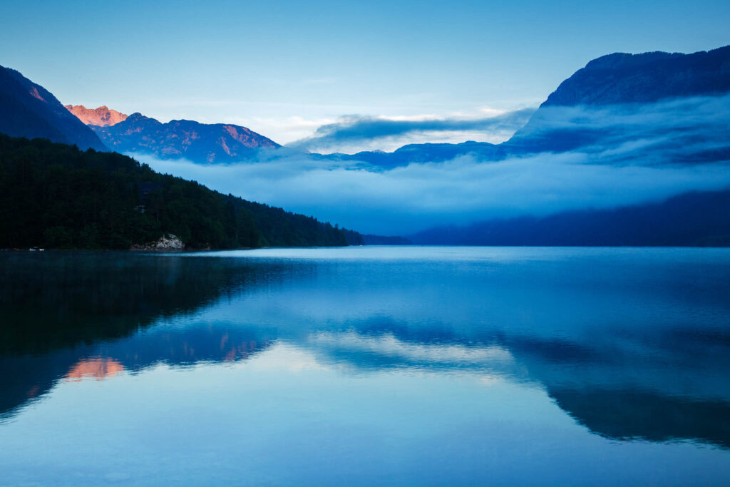 Morning mist and cloud over the Julian Alps at Lake Bohinj, Triglav National Park, Slovenia