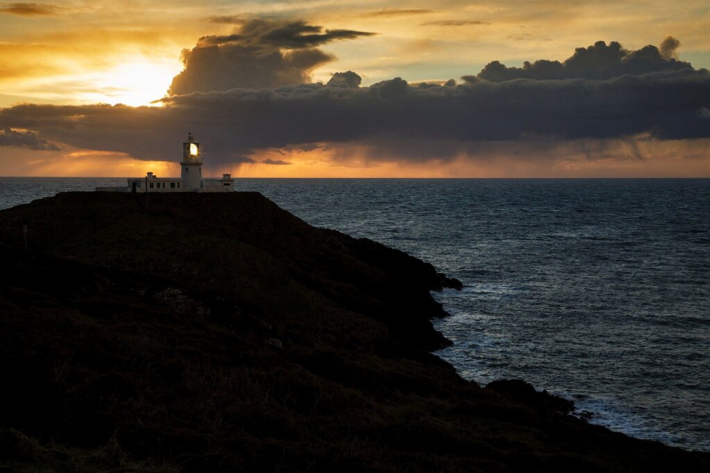 Lighthouse at Strumble Head at sunset, Pembrokeshire, Wales