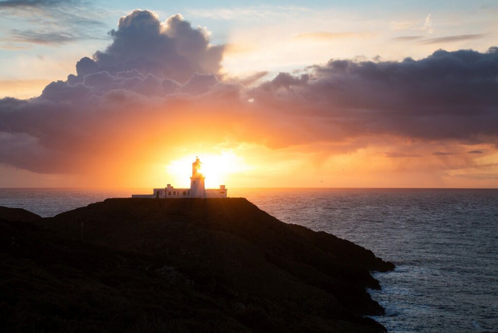 Lighthouse at Strumble Head at sunset, Pembrokeshire, Wales