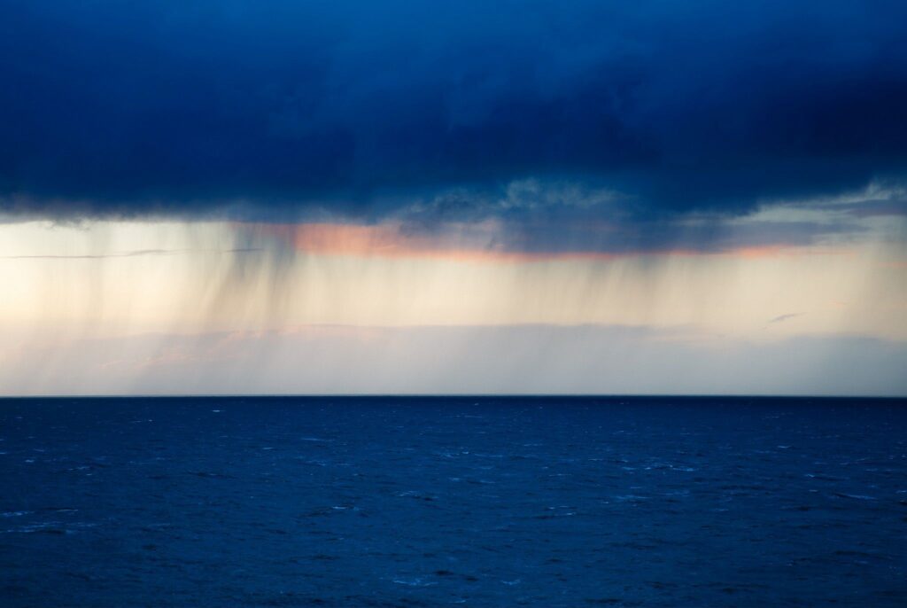 Rain on the horizon seen from Strumble Head at sundown, Pembrokeshire, Wales