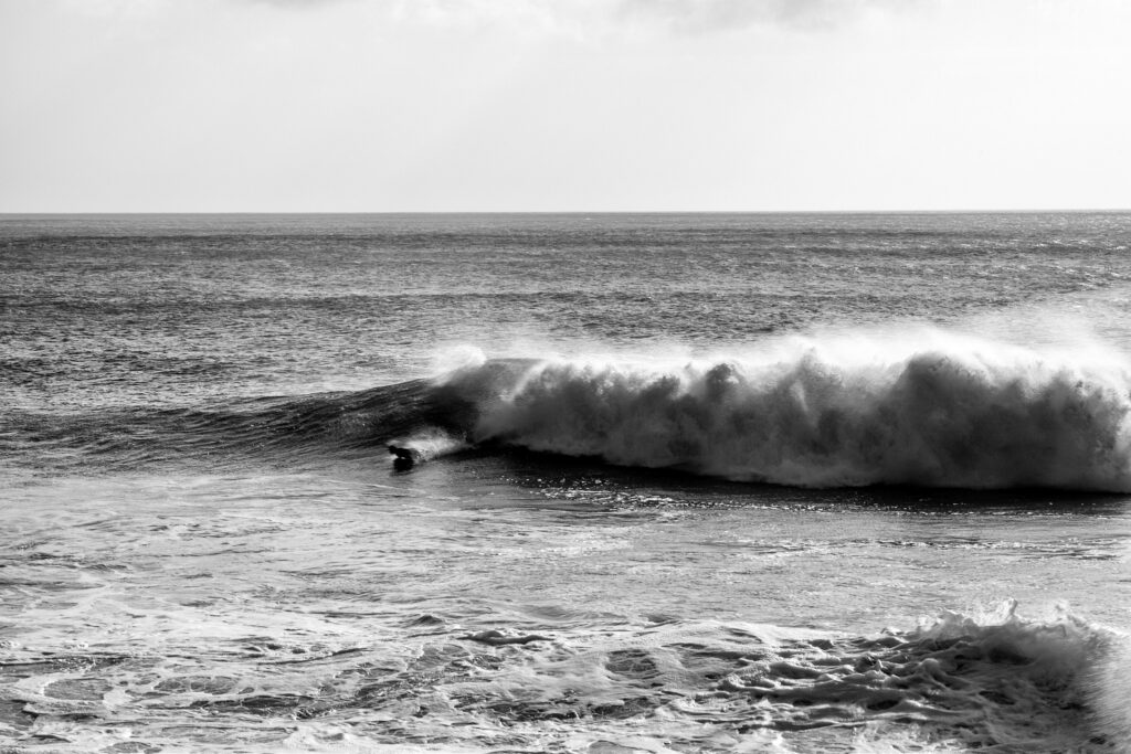 Bodyboarder riding a wave at Porthleven Beach, near Helston in Cornwall, England.