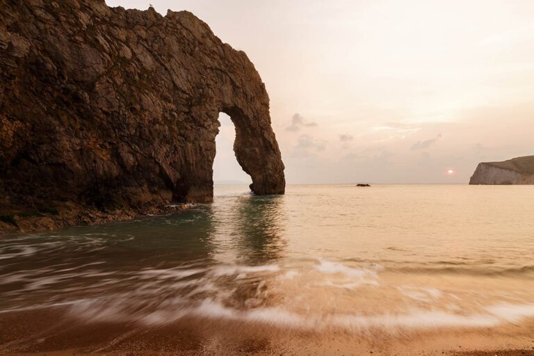 Durdle Door beach as the sun disappears for the day, Dorset, England