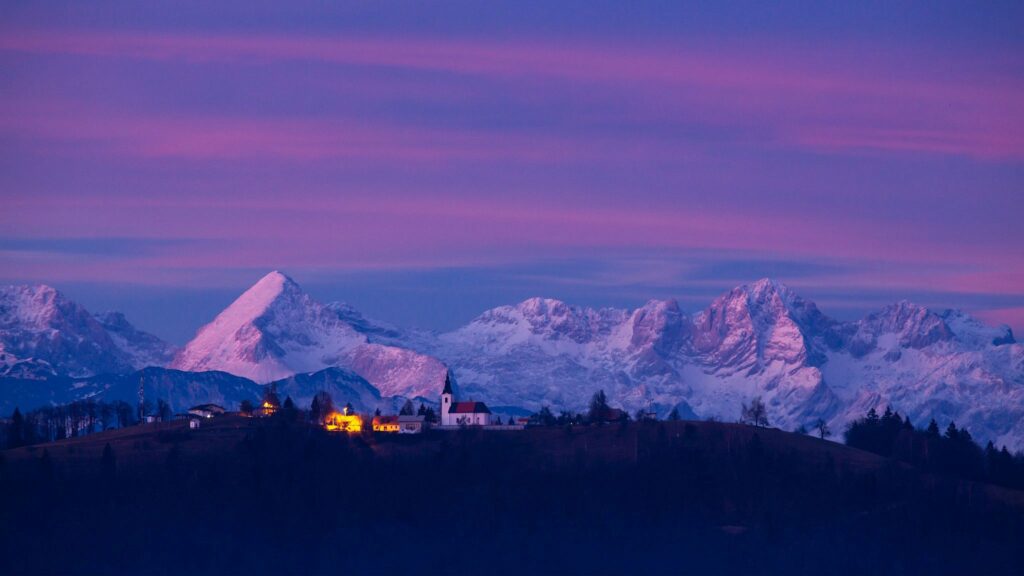 View across to the church of Saint Nicholas and the village of Jance at dusk, in the hilly region to the east of Ljubljana, Slovenia