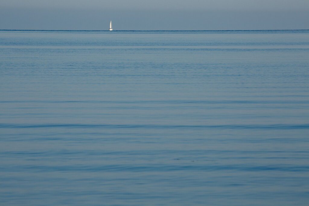 Sailing boat on the Adriatic Sea. Seen from Puntižela Beach, Štinjan north of Pula, Istria, Croatia.