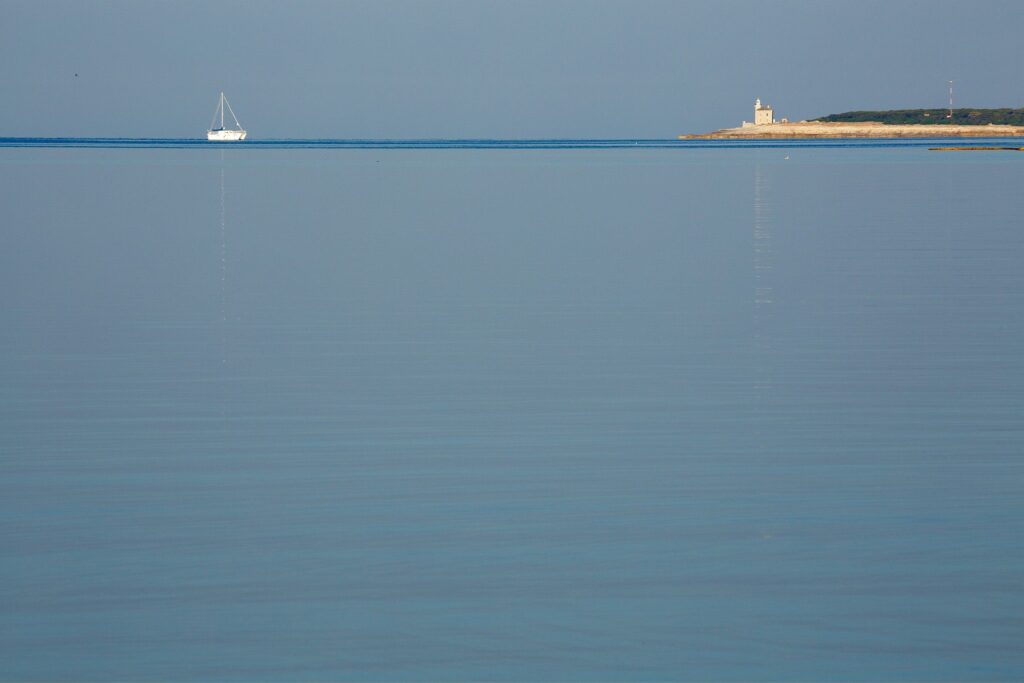 Lighthouse at the southern end of Veli Brijuni Island, Croatia. Seen from Puntižela Beach, Štinjan north of Pula.