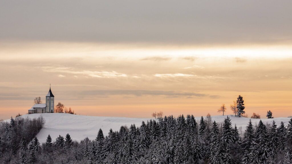 Jamnik church of Saints Primus and Felician in the morning in winter, perched on a hill on the Jelovica Plateau, Slovenia.