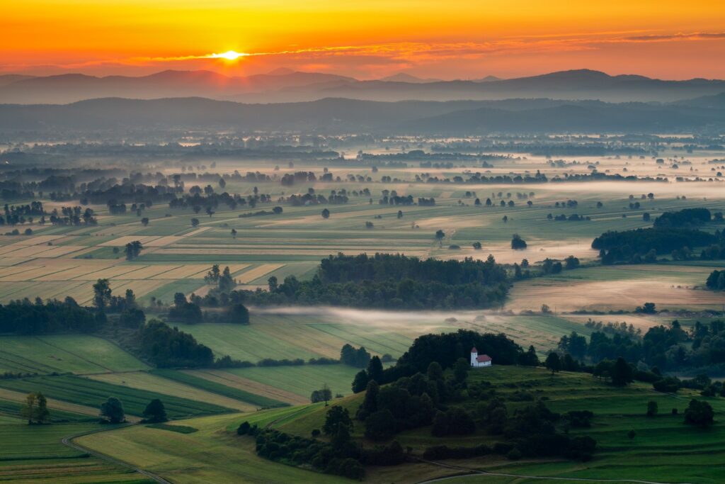 The church of sv. Lovrenc (Saint Lawrence) near Jezero on the Ljubljana Moors at sunrise (Ljubljansko Barje), a large area of wetland 160 square kilometres in size.