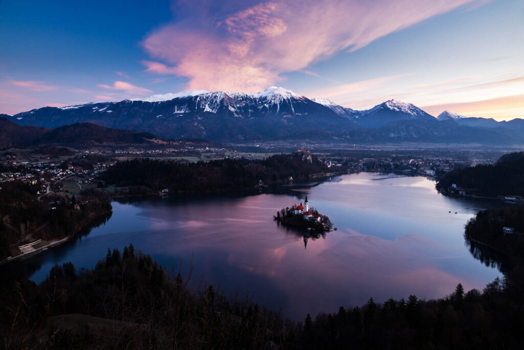 Sunrise over Lake Bled to the island church and clifftop castle from Mala Osojnica, Slovenia.