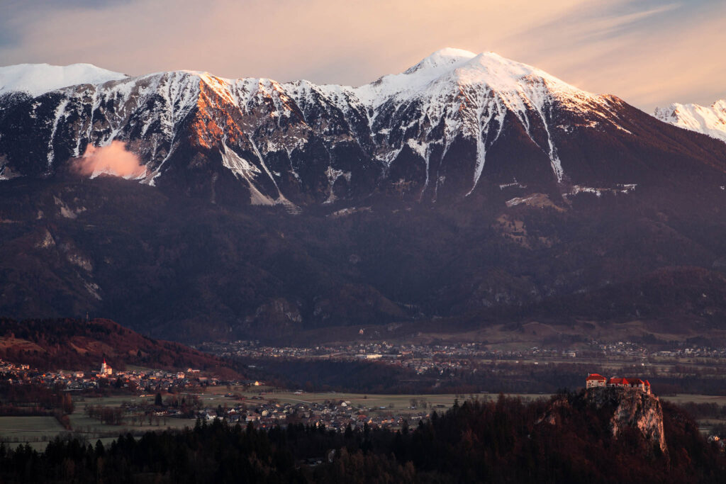 View across to the beautiful Lake Bled's hilltop castle with the Mt Stol and the Karavanke mountains forming a stunning backdrop. Seen in the morning from Mala Osojnica viewpoint.