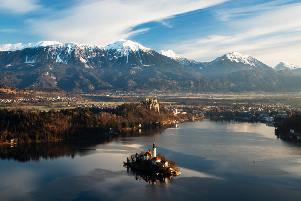 Morning over Lake Bled to the island church and clifftop castle from Mala Osojnica, Slovenia.