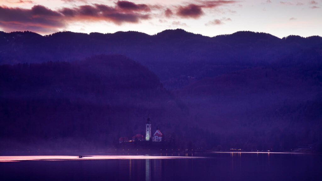 View across the beautiful Lake Bled, island church at sunset, Slovenia. Lake Bled is Slovenia's most popular tourist destination.