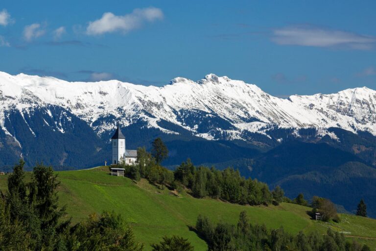 Jamnik church with Karavanke Alps backdrop