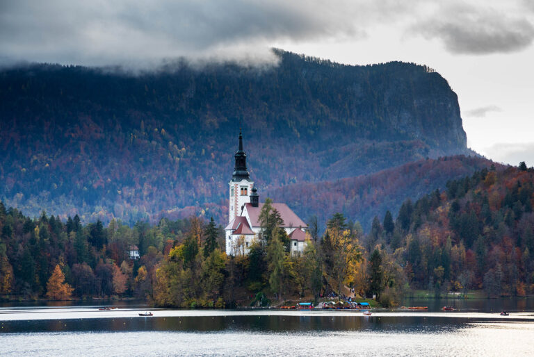 View across Lake Bled to the island church in all it's autumn glory, Slovenia.