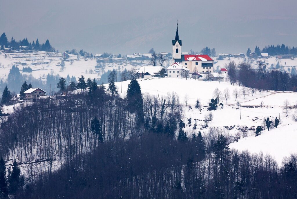 Winter scene of the church of Saint Marjeta in Prezganje in the Jance hills to the east of Ljubljana, Slovenia.