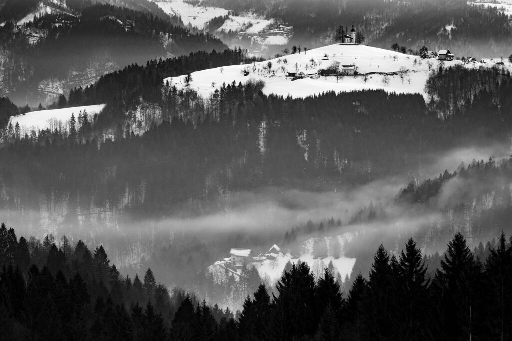 Morning view in winter from Rantovše hill across to Sveti Tomaz nad Praprotnim (church of Saint Thomas) and the Kamnik Alps, Slovenia.