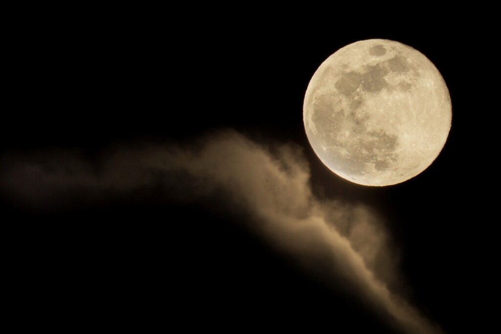 Blue moon of March 2018 rising out of the clouds after a rainstorm