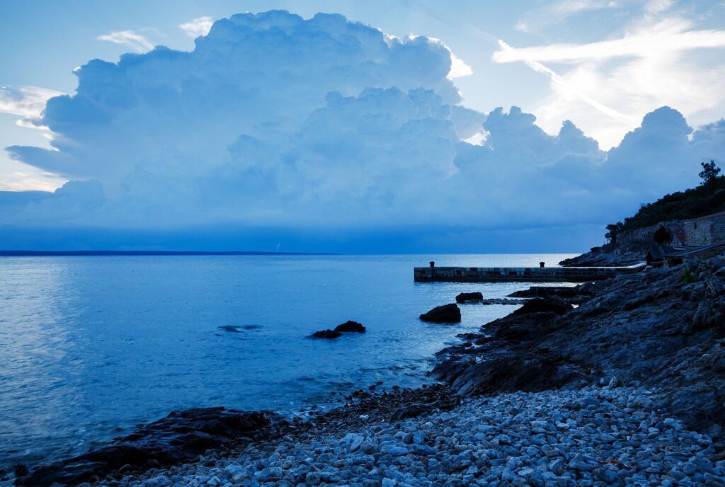 Morning light as a storm moves off over the rocky coastal area of Zaosiri Beach near Cunski. Cunski lies just 8kms north of Mali Losinj on Losinj Island, Croatia.