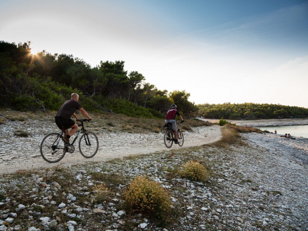 Cycling past Drazice Cove on the Kamenjak Peninsula, at the very tip of Istria in Croatia.