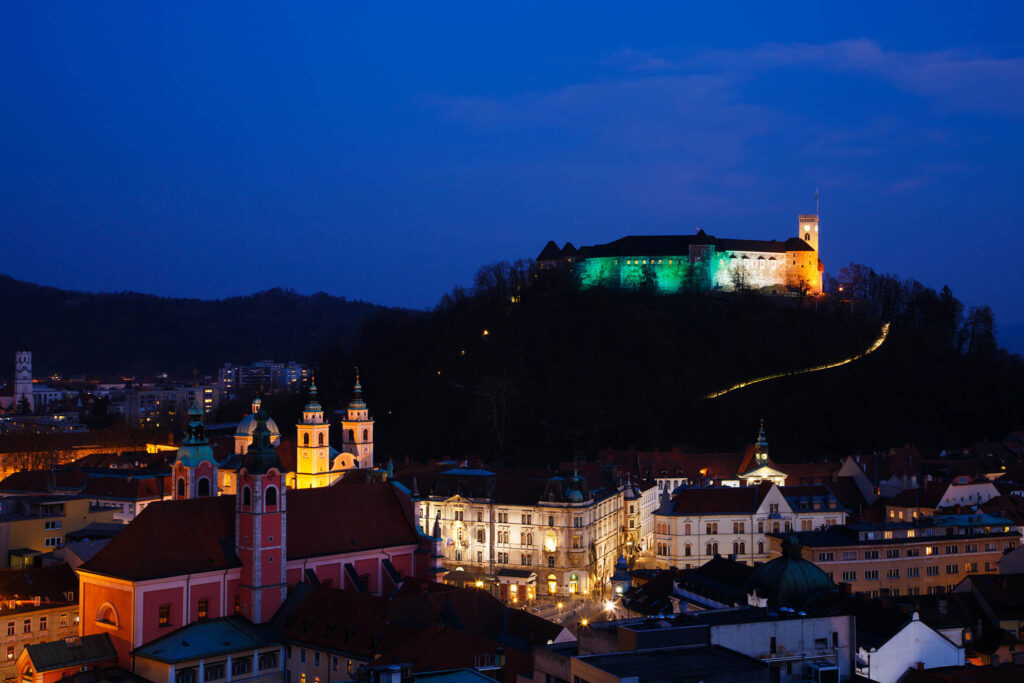 View down to the centre of Ljubljana and the Ljubljana Castle lit up in the colours of the Irish flag to celebrate Saint Patrick&#039;s Day weekend 2016 in Slovenia. The castle was lit up green last year to celebrate the event, but as Ljubljana is the European Green Capital for 2016 the castle is already being lit green at night for the whole year. So the Irish embassy arranged for the colours of the flag to adorn the castle for 2016.