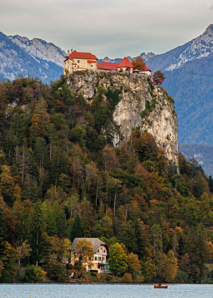 View across the beautiful Lake Bled to the hilltop castle in autumn.