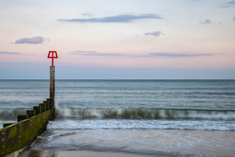 Bournemouth beach and groyne at sunset, Dorset, England