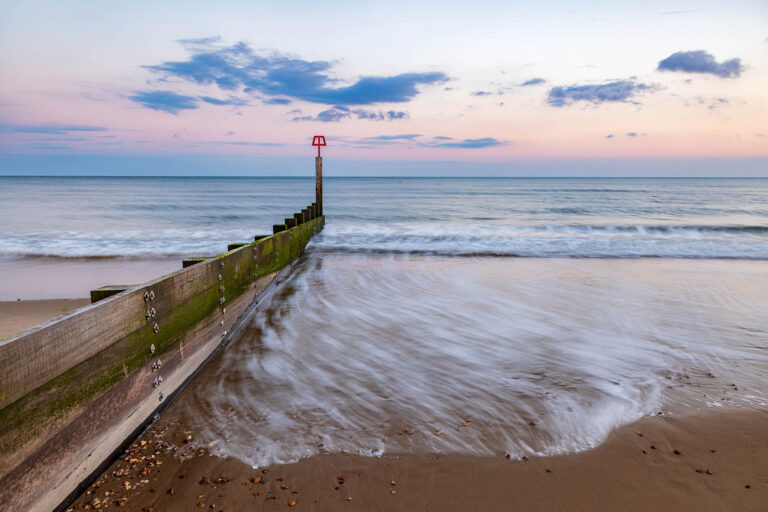 Bournemouth beach and groyne at sunset, Dorset, England