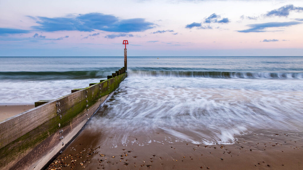 Bournemouth beach and groyne at sunset, Dorset, England