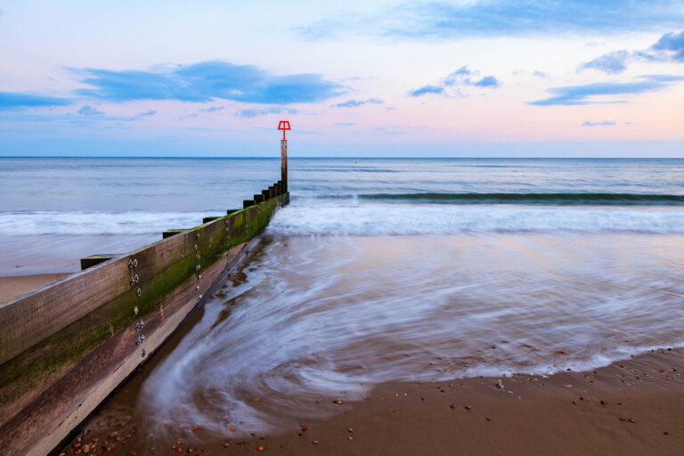 Bournemouth beach and groyne at sunset, Dorset, England