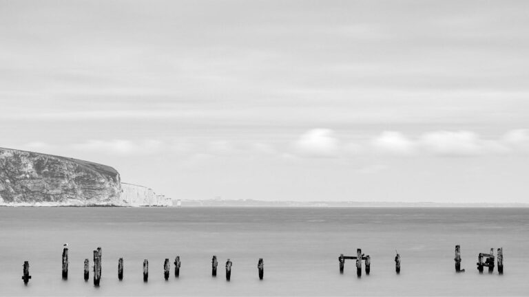 View of the old pier in Swanage with Old Harry Cliffs in the background, Dorset, England.