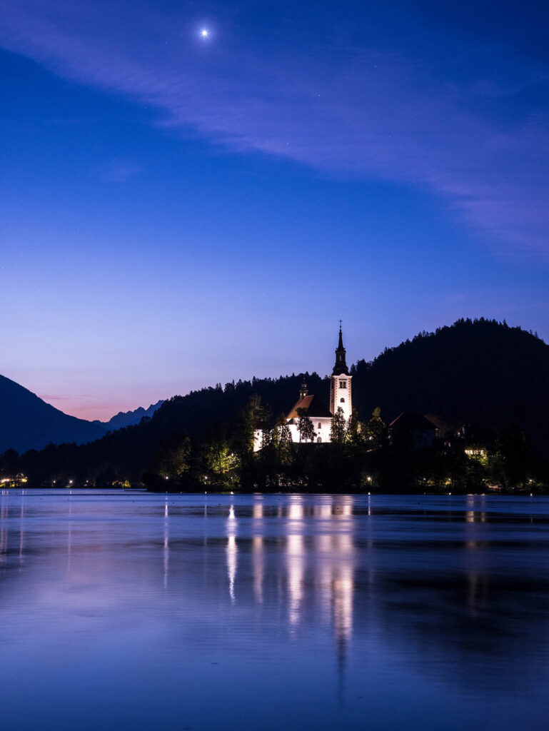 Venus rising at dawn over Lake Bled island church in Slovenia