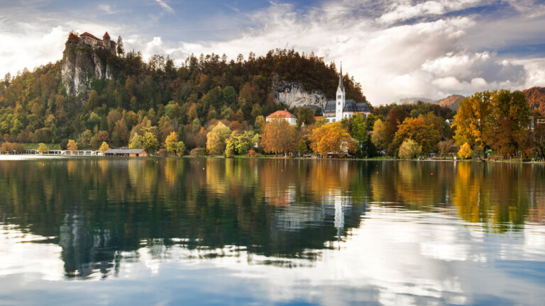 Lake Bled castle and church of Saint Martin during some soft afternoon autumn light, Slovenia.