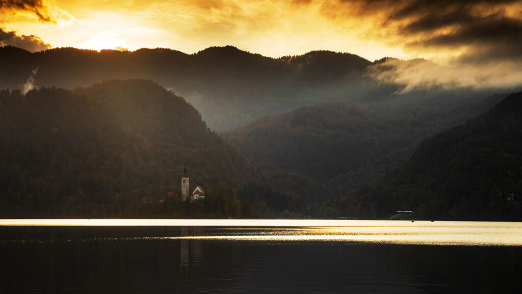 View across the beautiful Lake Bled, island church at sunset, Slovenia. Lake Bled is Slovenia's most popular tourist destination.