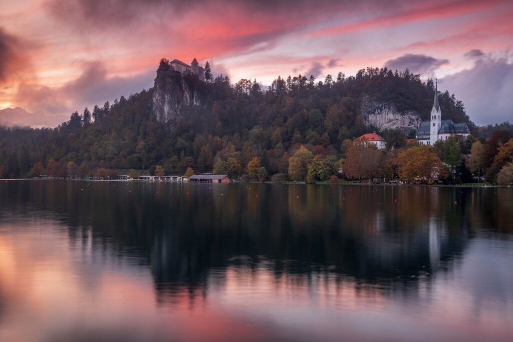 Sunset over Lake Bled and the hilltop castle with the Julian Alps in the background, Slovenia.